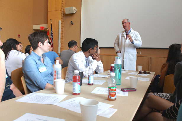 Chancellor Michael F. Collins speaks with first-year School of Medicine students.