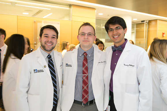 School of Medicine Class of 2018 students Jonathan Gammel, Martin Cotti and Nisarg Chhaya gather for the Class Oath Ceremony.