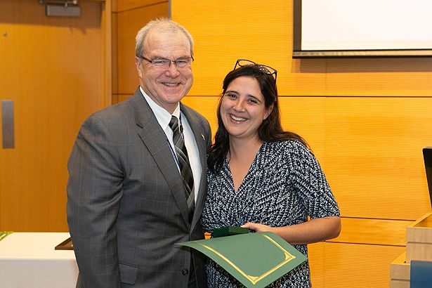 Alumna and faculty member Olga Valdman, MD, is congratulated by Dean Flotte.