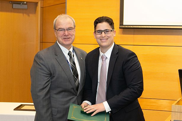 Surgery resident Jonathan Green, MD, (right) is one of three residents inducted by Dean Flotte.