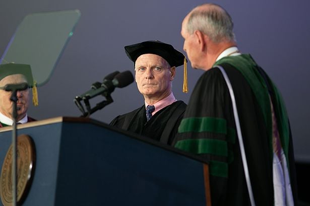 Chancellor Collins presents Rich Kennedy with an honorary degree.