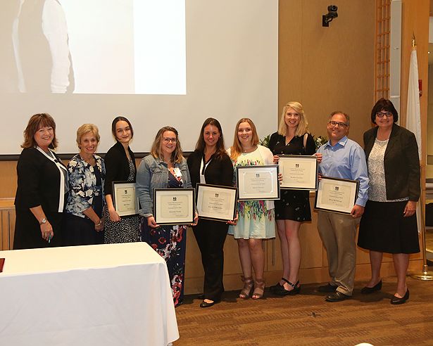 From left: Jill Terrien and Dean Vitello with GSN Community Service Award winners and faculty advisor Jean Boucher