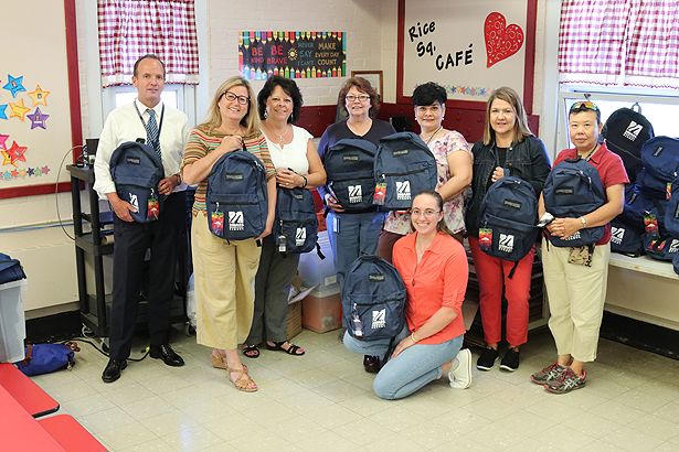 Members of the UMass Chan Medical School community prepare to distribute backpacks to students at Rice Square Elementary School.