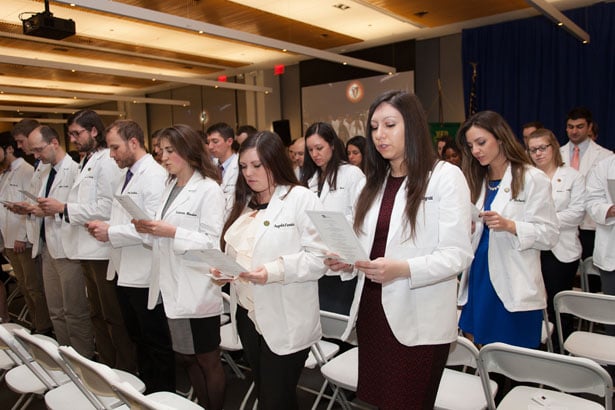 The School of Medicine Class of 2017 recites their oath, which they have written as a class.