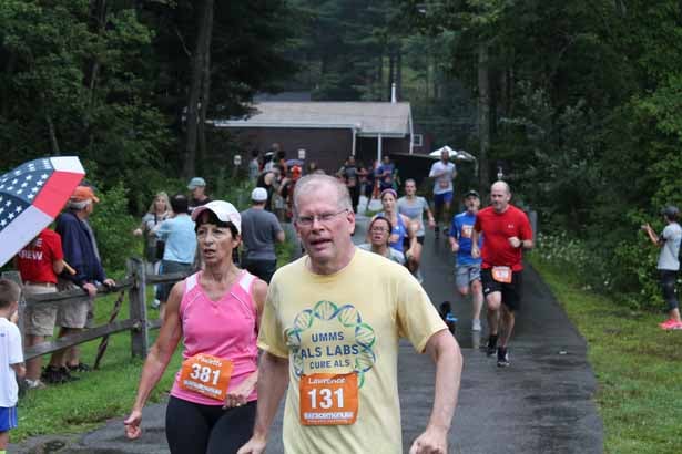 Lawrence Hayward, MD, PhD, professor of neurology at UMMS, crosses the finish line at the Governor Cellucci Tribute Road Race.
