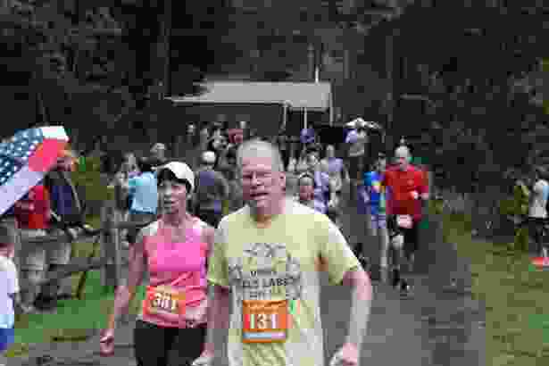 Lawrence Hayward, MD, PhD, professor of neurology at UMMS, crosses the finish line at the Governor Cellucci Tribute Road Race.