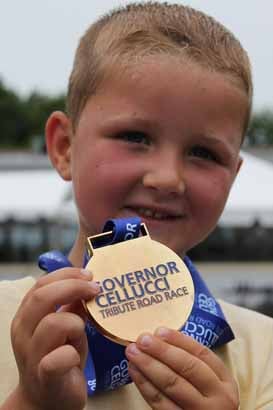Brayden Huban of Clinton shows off his medal for taking part in the inaugural Governor Cellucci Tribute Road Race.