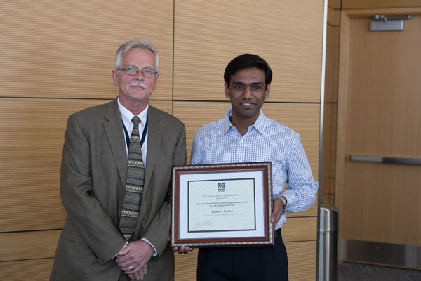 Sumeet Nayak accepts the Outstanding Mentoring Award from Dean Carruthers.