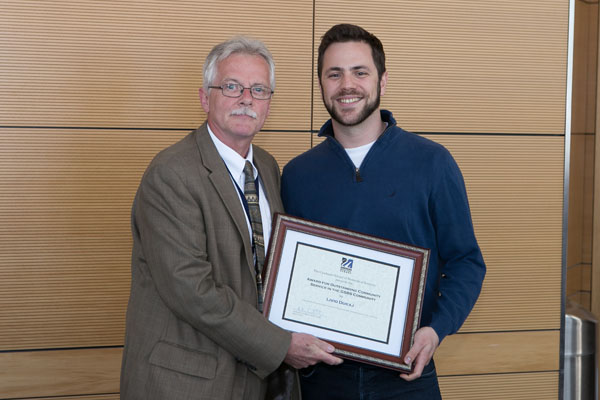 Livio Dukaj is given the Outstanding Community Service Award from Dean Carruthers.