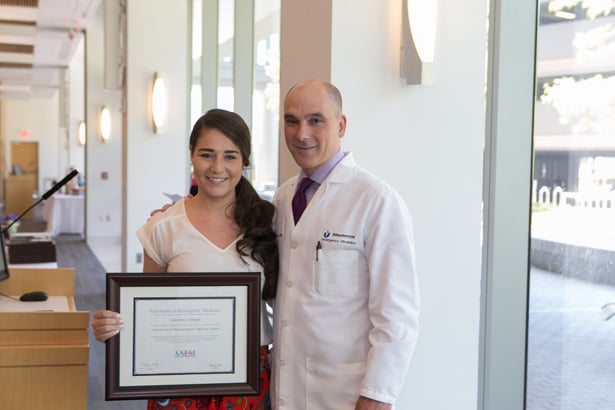 Courtney Temple accepts the national Excellence in Emergency Medicine Award from Romolo Gaspari, MD.
