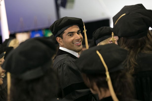 SOM graduate Jacob Koshy lines up to cross the stage and receive his degree.