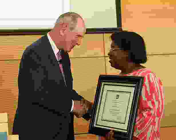 Chancellor Michael F. Collins congratulates Chancellor’s Award winner Colette Dieujuste.