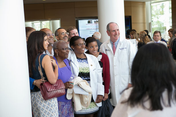 Chancellor Michael F. Collins (far right) with Kayla R. Elliott of Blackstone House and well-wishers.