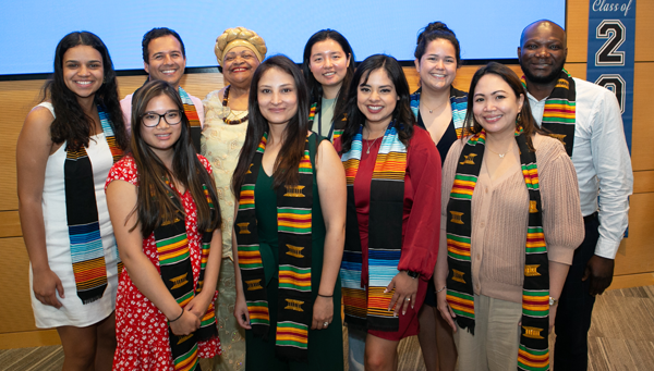 Students wearing stoles, with Deborah Harmon Hines