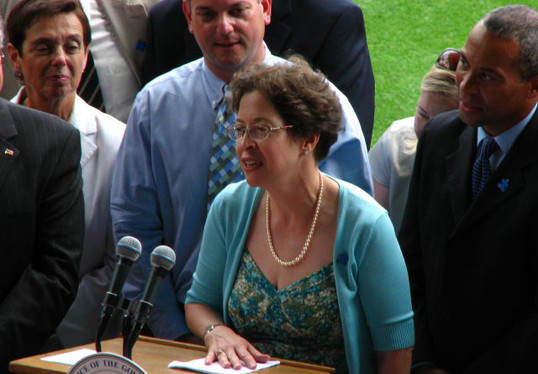 Shriver Center autism insurance advocate Amy Weinstock is pictured here with Governor Patrick when, in 2010, he signed Massachusetts’ first law requiring insurance coverage for autism treatment.