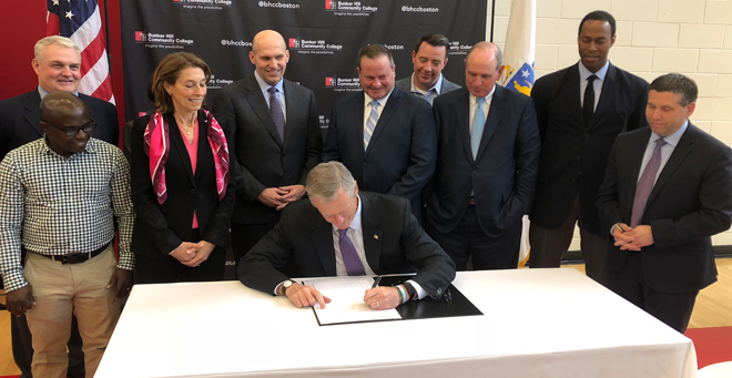 Massachusetts Gov. Michael Baker signs the Life Science Bond Bill into law at Bunker Hill Community College on Friday, June 15.