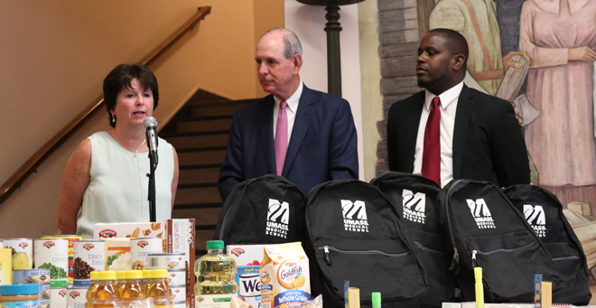 Worcester Public Schools Superintendent Maureen Binienda thanks UMass Medical School for supporting the schools with a new initiative, as UMMS Chancellor Michael F. Collins and Community & Government Relations Senior Director Kolawole Akindele look on.