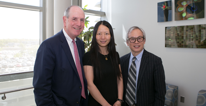 UMass Medical School Chancellor Michael Collins poses with Zhiping Weng and Li Weibo