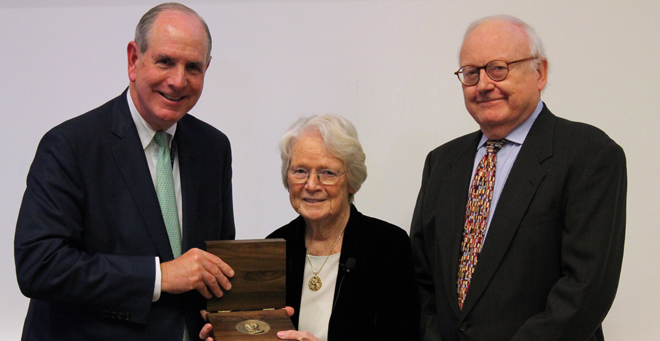 Patricia Donahoe accepts the 2018 Pincus Medal from Chancellor Collins (left) and Thoru Pederson