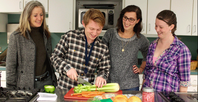 Jeffrey Larnard cuts celery for a recent class while (from left) Barbara Olendzki, Sydney Greenberg and Molly Cain observe. 