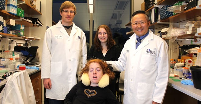 In the Gao lab are, (from left,) Dominic Gessler, Rachel Epstein (seated), her sister, Jessica, and Guangping Gao, PhD.