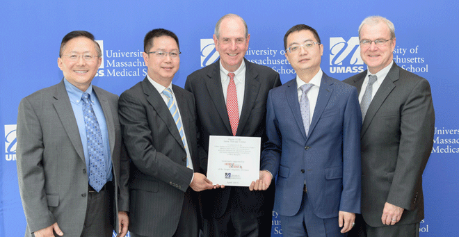 Chancellor Michael F. Collins (center) joins (from left) Guangping Gao, PhD; P.J. “Chuck” Chen; Yuet Chai; and Terence R. Flotte, MD, at an event announcing a $2 million gift from the Horae Oriental Shenzhen Investment Company of Guangdong, China, and the renaming of the UMMS Gene Therapy Center the Horae Gene Therapy Center in recognition of the gift.