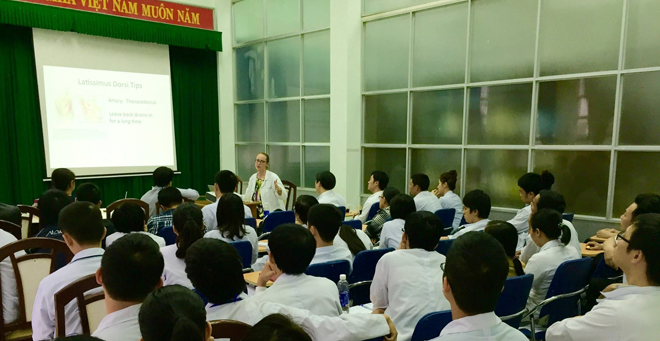 Joyce McIntyre, MD, presents a grand rounds with medical students and surgery residents at the Huế School of Medicine and Pharmacy in Vietnam. 