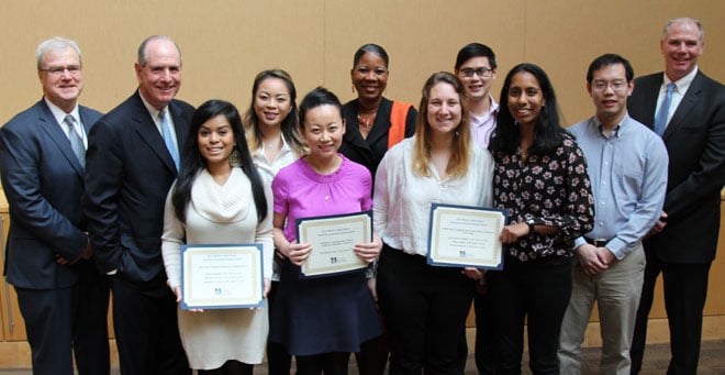 Dean Terence Flotte, (far left), Chancellor Michael Collins (left), YWCA USA CEO Dara Richardson-Heron (at back) and UMass Memorial Health Care President & CEO Eric Dickson (right) stand with some of the UMMS students who were awarded MLK Semester of Service grants.