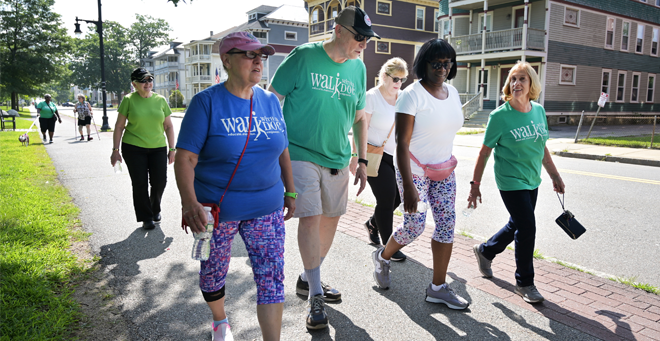 Michael Hirsh, MD, walks with community members Aug. 4 at Elm Park in Worcester.