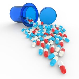 Colorful pills spilling from bottle