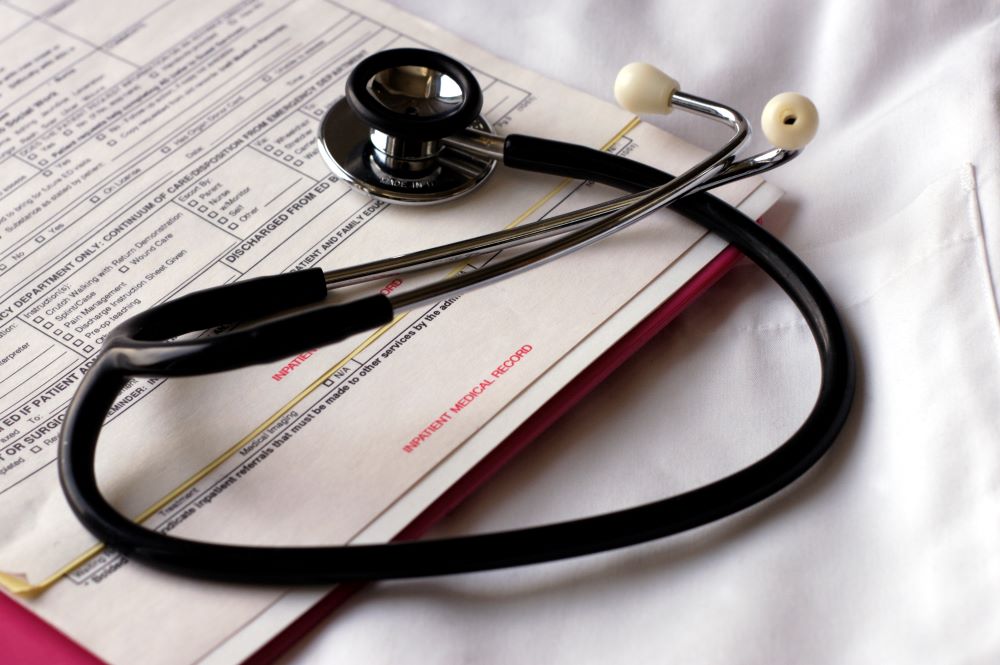stethoscope lying on top of a medical intake form