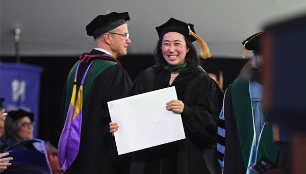 A 2022 UMass Chan Medical School graduate crosses the stage