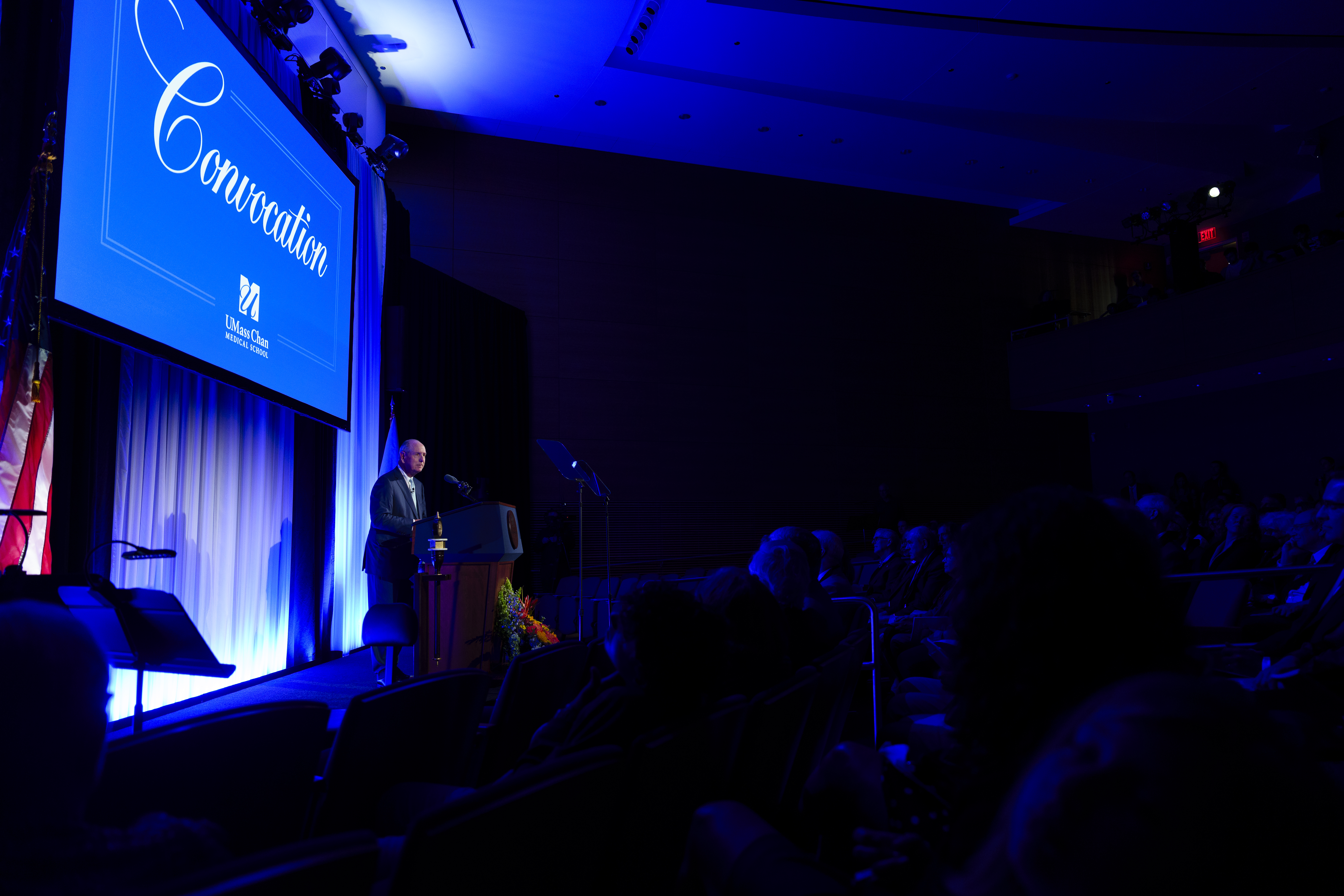 Chancellor Collins standing on stage